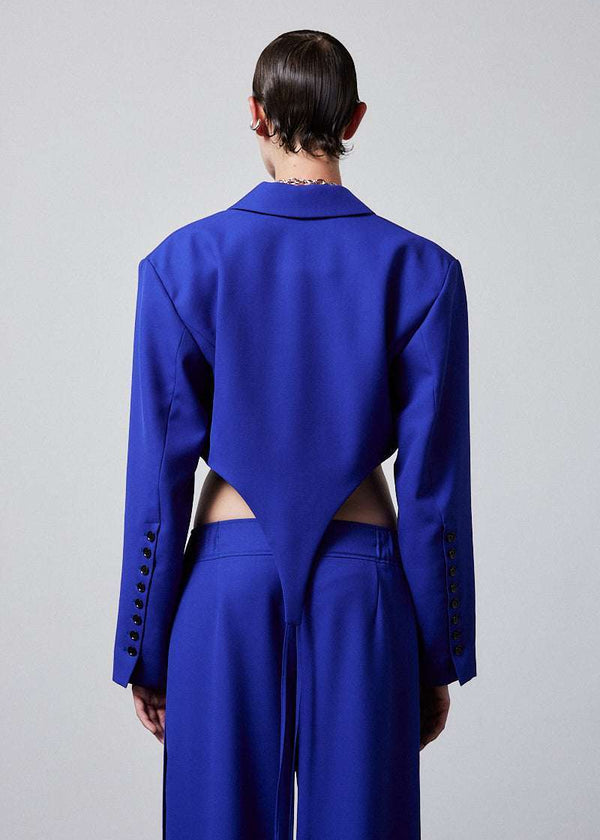 INTERNATIONAL CITIZEN.  Style: The French-Cut Jacket is oversized in the fit with a high french-cut hemline. Unisex item. Back photo. Made of Italian Wool, Lapis Lazuli blue. Spiritually Infused, Sustainable Luxury Fashion in Berlin.