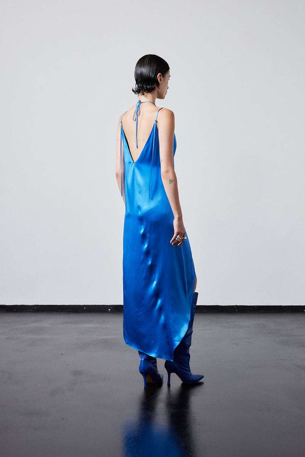 INTERNATIONAL CITIZEN.  Style: The Crystalline Dress. Crystalline Dress satin blue gown with back tie. Made of Organic Silk, Azurite Blue. Spiritually Infused, Sustainable Luxury Fashion in Berlin.