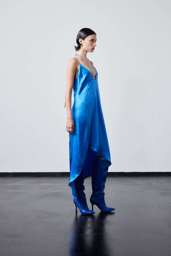 INTERNATIONAL CITIZEN.  Style: The Crystalline Dress. Crystalline Dress satin blue slip dress with side angel hemline. Made of Organic Silk, Azurite Blue. Spiritually Infused, Sustainable Luxury Fashion in Berlin.