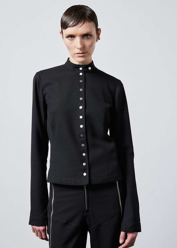 INTERNATIONAL CITIZEN.  Style: The Lunar Shacket is a slim jacket that wears like a shirt. It is lined with silver snaps down the front closure and sleeve vent. It has a bias under sleeve for a slim fit, extra-long sleeves, and an elastic back waist. Made of Italian Wool RWS, Obsidian Black. Spiritually Infused, Sustainable Luxury Fashion in Berlin.