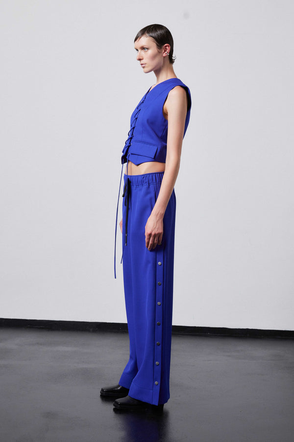 INTERNATIONAL CITIZEN.  Style: The Stitch Vest. Made of Italian Wool RWS, Lapis Lazuli Blue. Spiritually Infused, Sustainable Luxury Fashion in Berlin. Side front photo.