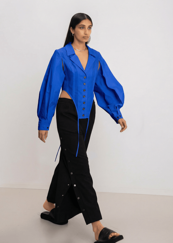 INTERNATIONAL CITIZEN.  Style: A French Cut Button Bodysuit with tie closures. Full body photo. Made of Italian Organic Cotton, Lapis lazuli Blue. Spiritually Infused, Sustainable Luxury Fashion in Berlin.