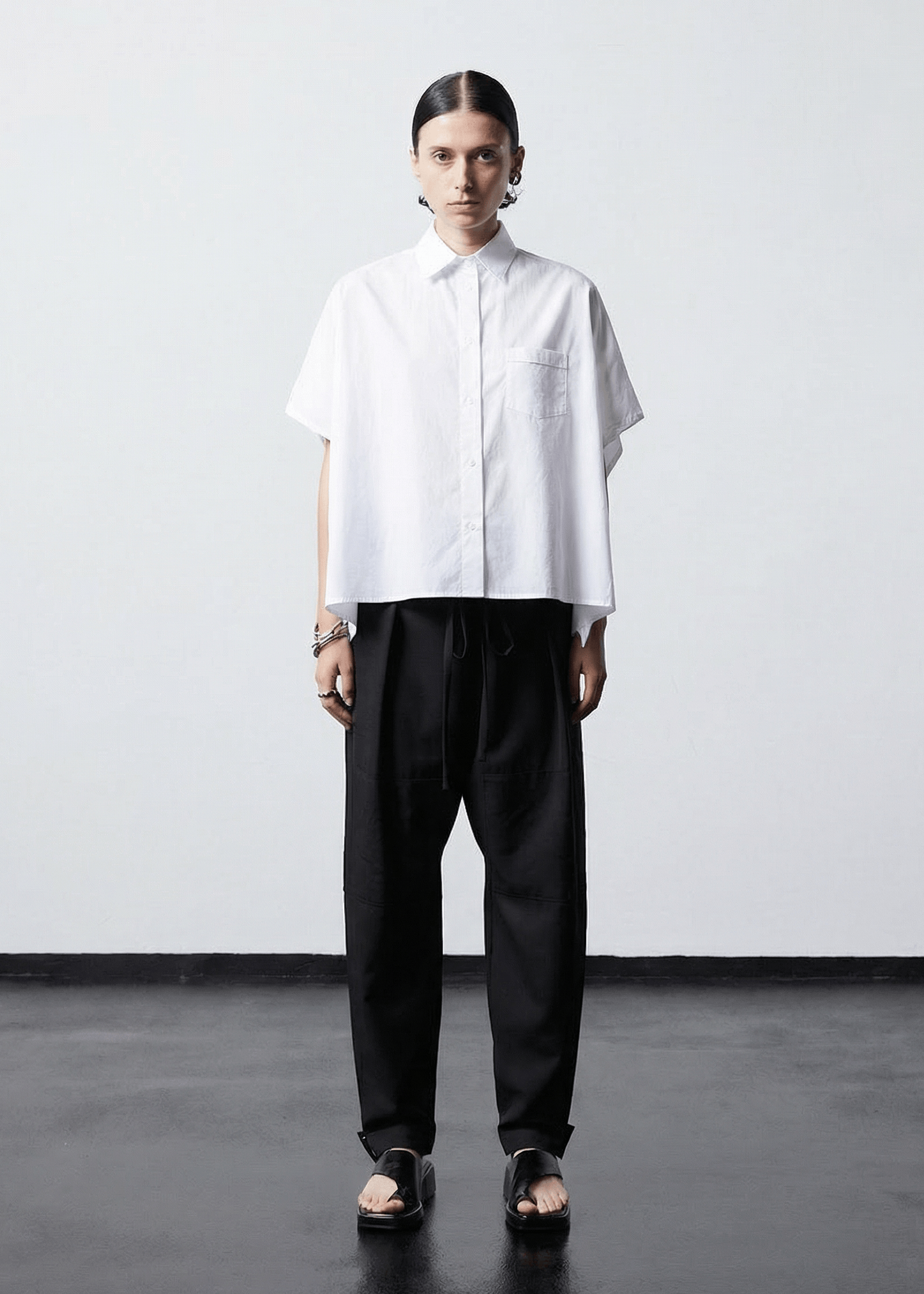 INTERNATIONAL CITIZEN.  Style: The Cubism Shirt is a 3-dimensional cube tilted on its axes to create a boxy minimal front body and a utility pen pocket on the chest. Unisex Item. Made of Italian Organic Cotton, White Quartz. Spiritually Infused, Sustainable Luxury Fashion in Berlin.