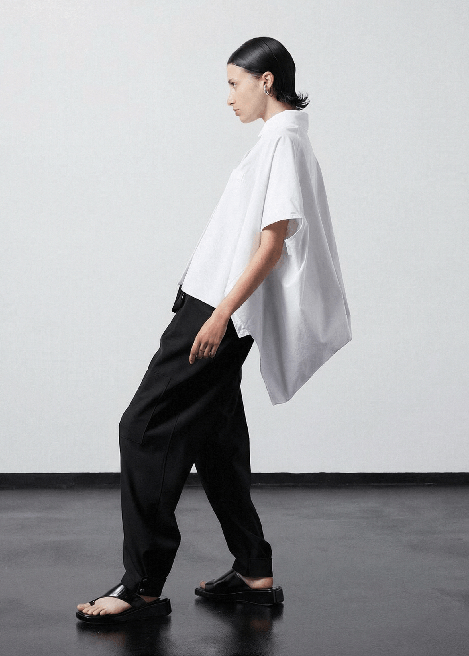 INTERNATIONAL CITIZEN.  Style: The Cubism Shirt is a 3-dimensional cube tilted on its axes to create a boxy minimal front body. Side view. Unisex Item. Made of Italian Organic Cotton, White Quartz. Spiritually Infused, Sustainable Luxury Fashion in Berlin.