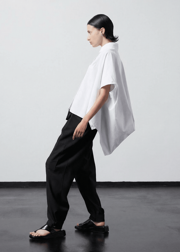 INTERNATIONAL CITIZEN.  Style: The Cubism Shirt is a 3-dimensional cube tilted on its axes to create a boxy minimal front body. Side view. Unisex Item. Made of Italian Organic Cotton, White Quartz. Spiritually Infused, Sustainable Luxury Fashion in Berlin.