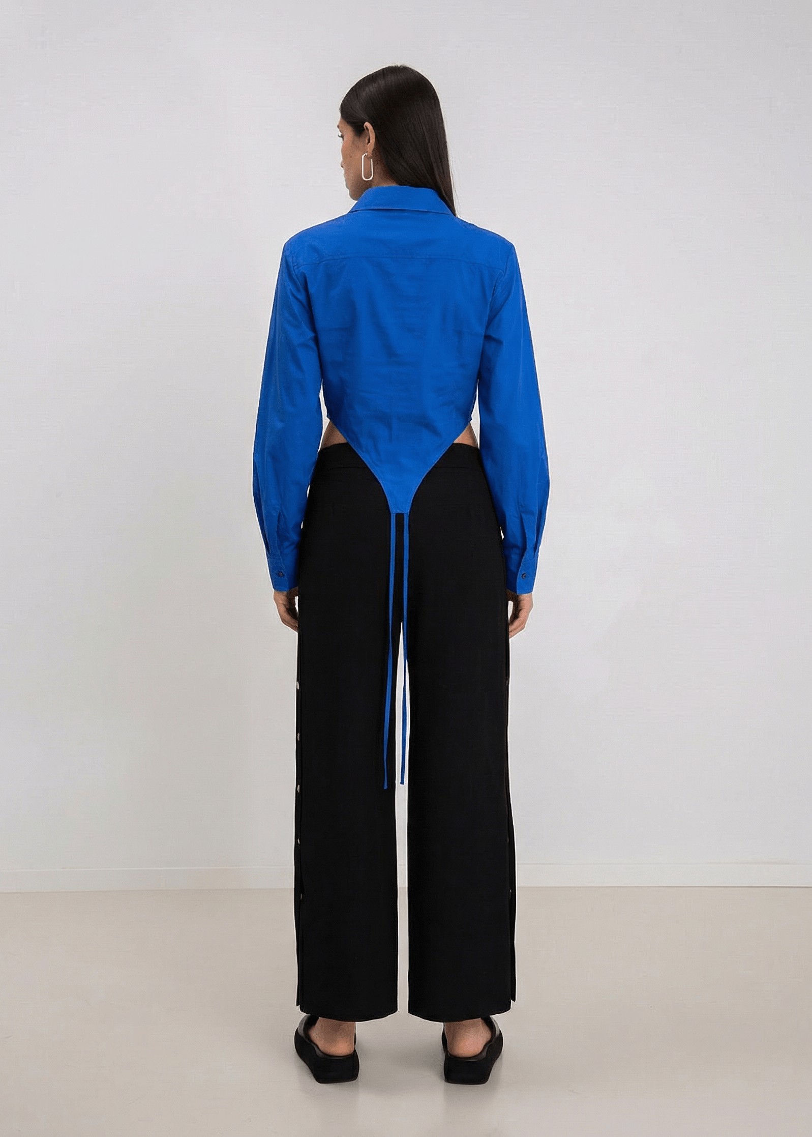 INTERNATIONAL CITIZEN.  Style: A French Cut Button Bodysuit with tie closures. Full back body photo. Made of Italian Organic Cotton, Lapis lazuli Blue. Spiritually Infused, Sustainable Luxury Fashion in Berlin.
