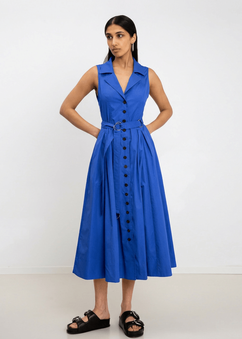 INTERNATIONAL CITIZEN.  Style: Button Dress. A Button Dress with princess seams that open to box pleats below the hips. Detachable belt with silver ring details for closure. The dress is made of Italian organic Cotton in Lapis Lazuli. Spiritually Infused, Sustainable Luxury Fashion in Berlin.