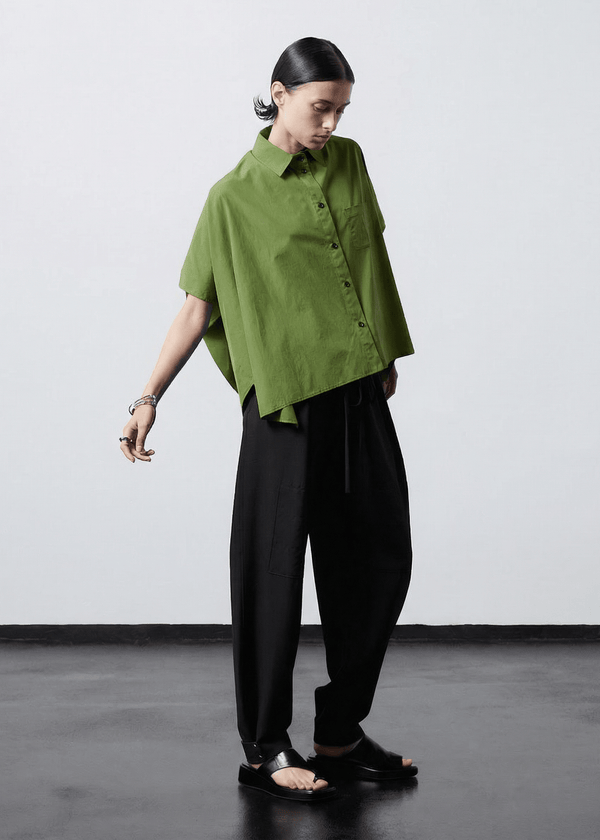 INTERNATIONAL CITIZEN.  Style: The Cubism Shirt is a 3-dimensional cube tilted on its axes to create a boxy minimal front body and dramatic drape in the back body. Full body view. Unisex Item. Made of Italian Organic Cotton,Nephrite Jade Green. Spiritually Infused, Sustainable Luxury Fashion in Berlin.