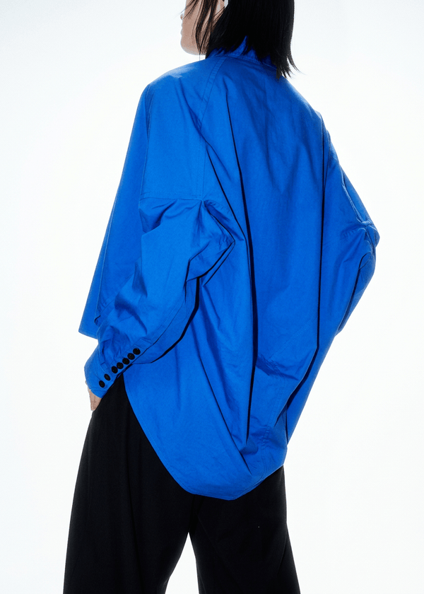 INTERNATIONAL CITIZEN.  Style: The Cubism Shirt is a 3-dimensional cube tilted on its axes to create a boxy minimal and dramatic drape in the back body. Unisex Item. Made of Italian Organic Cotton, Lapis Lazuli Blue. Spiritually Infused, Sustainable Luxury Fashion in Berlin.