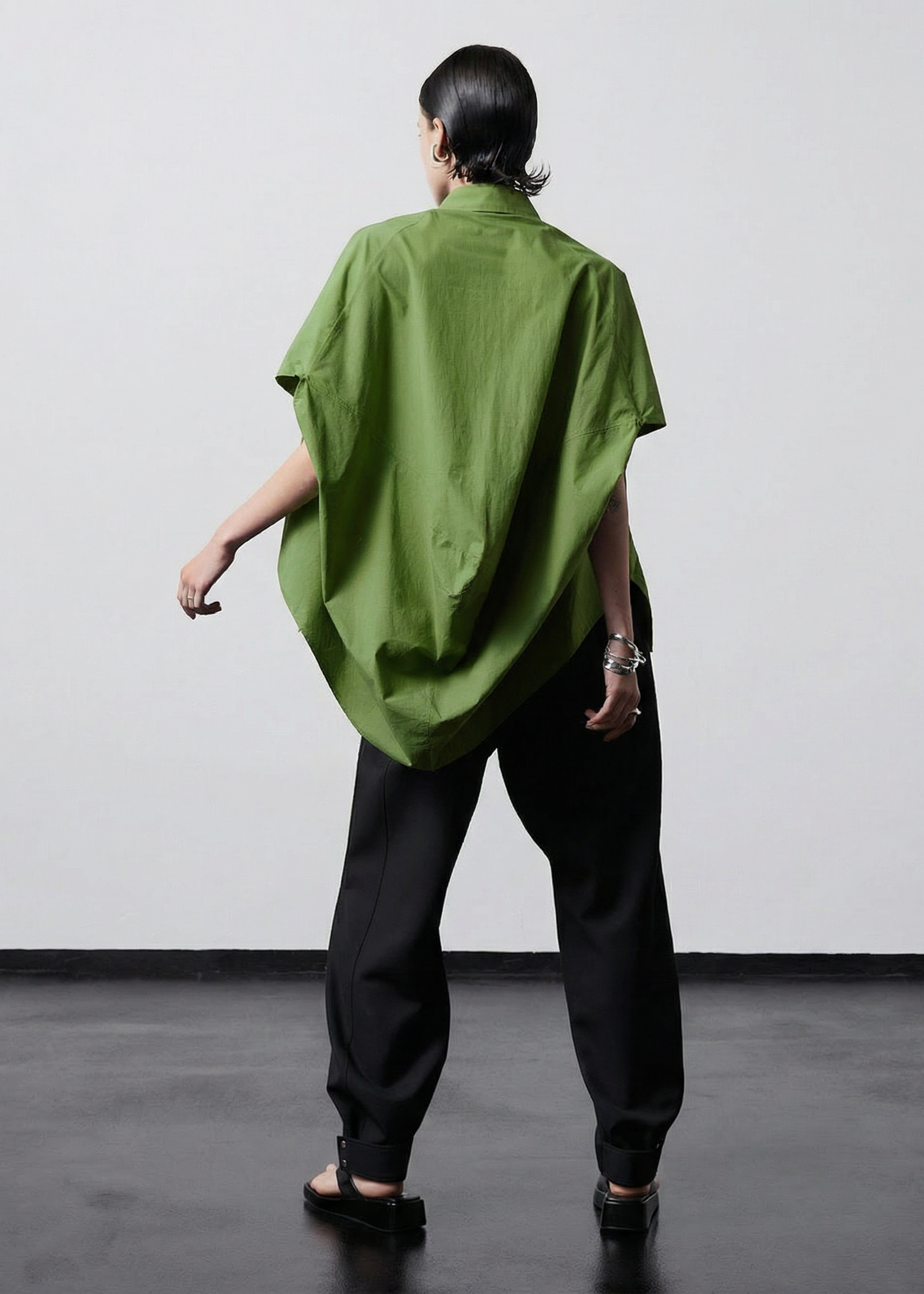 INTERNATIONAL CITIZEN.  Style: The Cubism Shirt is a 3-dimensional cube tilted on its axes to create a dramatic drape in the back body. Full body back view. Unisex Item. Made of Italian Organic Cotton,Nephrite Jade Green. Spiritually Infused, Sustainable Luxury Fashion in Berlin.