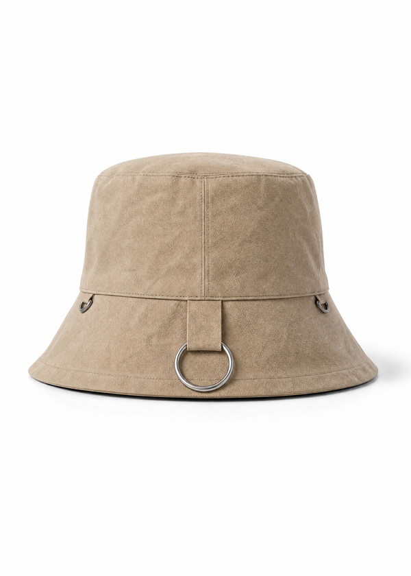 INTERNATIONAL CITIZEN.  Style: The Charm Bucket Hat. Back view. A unisex hat with utility details that feature our signature silver ring at the back and mini rings around the rim to clip your charms.  Made of Italian Organic Cotton Twill, Dune. Spiritually Infused, Sustainable Luxury Fashion in Berlin.
