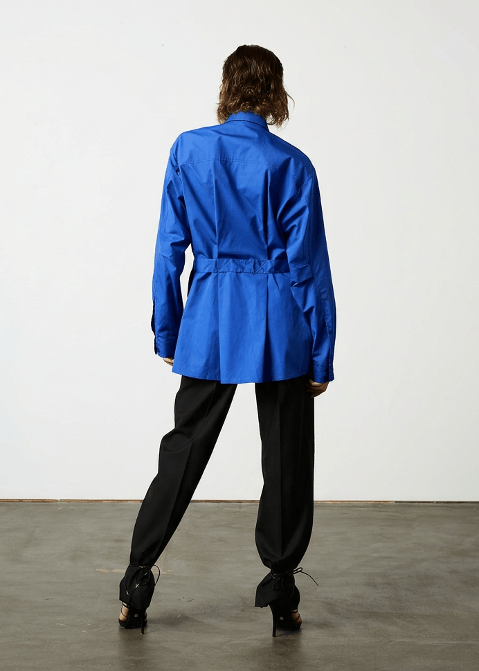 INTERNATIONAL CITIZEN.  Style: Artist Shirt. An oversized fit with and back belt ties that adjust at the front with silver rings. The shirt are made of Italian organic Cotton in Lapis Lazuli Blue. Spiritually Infused, Sustainable Luxury Fashion in Berlin.