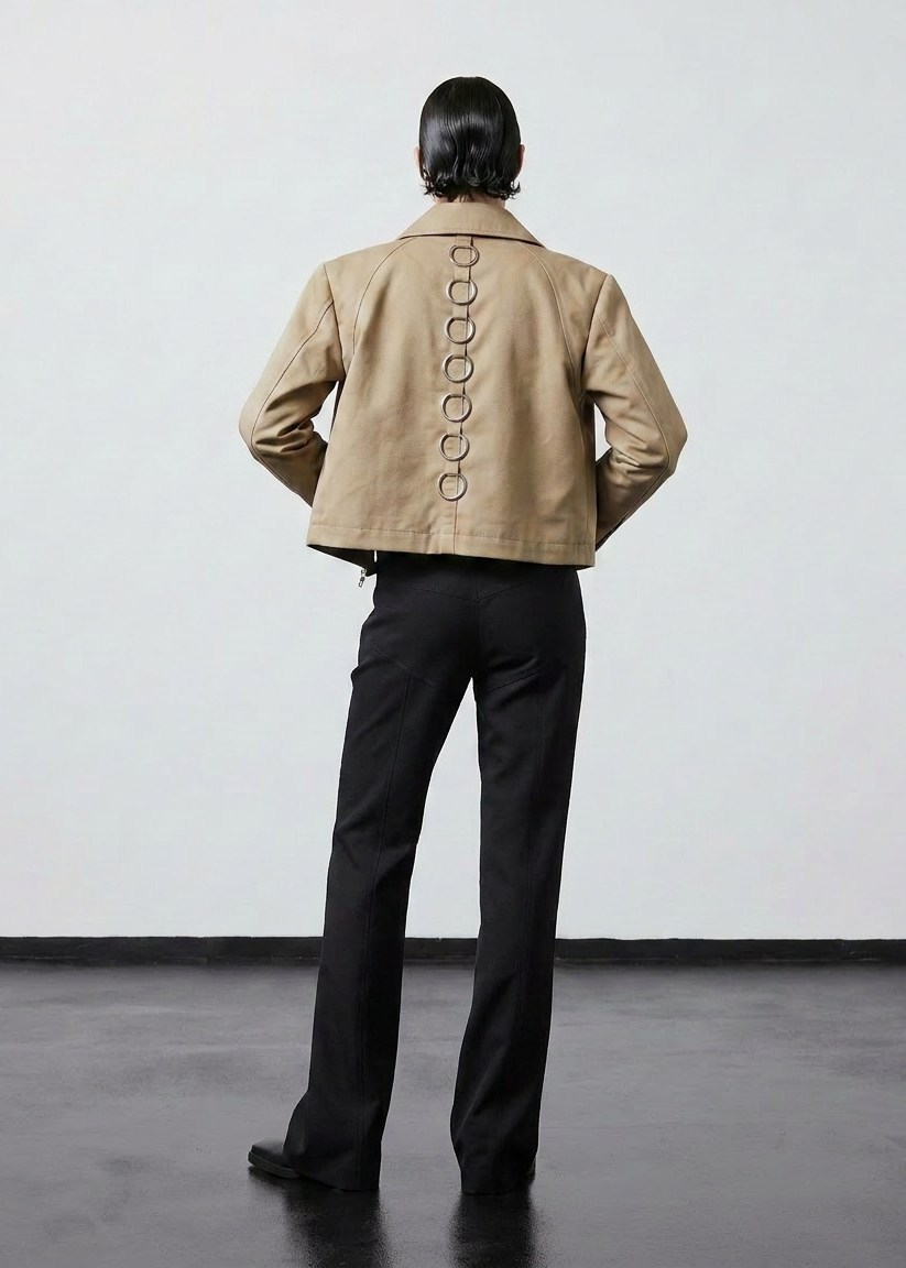 INTERNATIONAL CITIZEN.  Style: Ajna Jacket. A black boxy jacket with sporty tailoring, featuring 7 rings down the back. The jacket is made from of Italian Organic Cotton Twill, Dune. Spiritually Infused, Sustainable Luxury Fashion in Berlin.