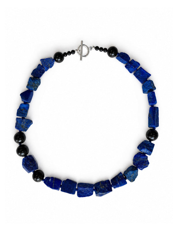 The Nuit Necklace energetically connects to the Third Eye Chakra. The energy center in located at between the eyes. It represents spiritual intuition, perception and spiritual insight, serving as a gateway to higher consciousness and inner wisdom. Made of genuine Lapis Lazuli &amp; Obsidian.