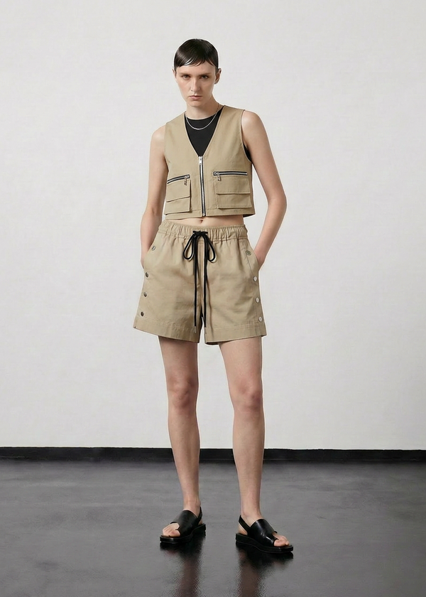 INTERNATIONAL CITIZEN.  Style: The Mini Zipper Vest has double pocket detailing with both a patch pocket and zipper welt with exposed pocket bags. Full front view. Made of Organic Cotton, Dune. Spiritually Infused, Sustainable Luxury Fashion in Berlin.