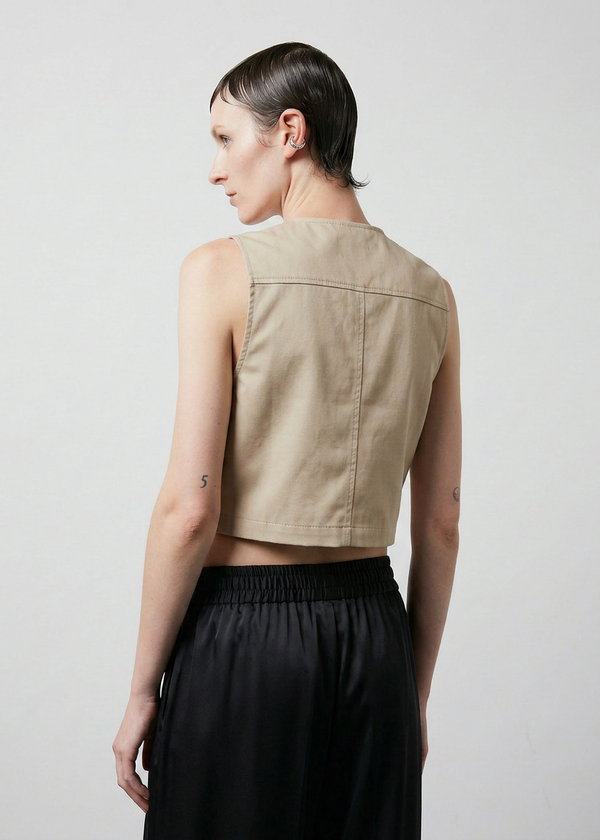 INTERNATIONAL CITIZEN.  Style: The Mini Zipper Vest. It is fully lined with cotton poplin. Back view. Made of Organic Cotton, Dune. Spiritually Infused, Sustainable Luxury Fashion in Berlin.