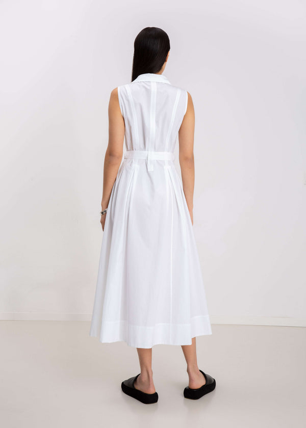 INTERNATIONAL CITIZEN.  Style: Button Dress. Full body back view. A Dress with princess seams that open to box pleats below the hips. The dress is made of Italian organic Cotton in White Quartz. Spiritually Infused, Sustainable Luxury Fashion in Berlin.