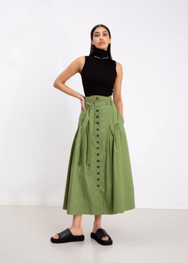 INTERNATIONAL CITIZEN.  Style: Button Skirt. A Button Skirt with box pleats below the hips. Front full view. The skirt is made of Italian organic Cotton in Nephrite Jade. Spiritually Infused, Sustainable Luxury Fashion in Berlin.