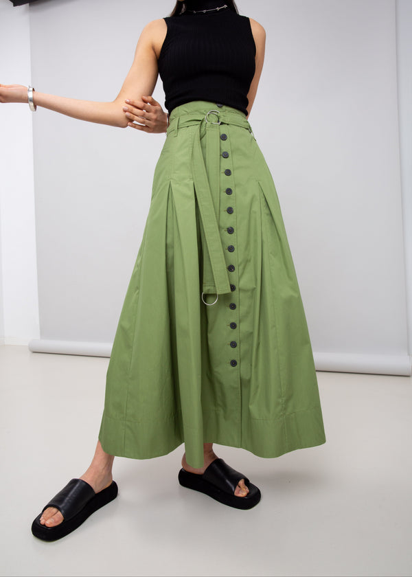 INTERNATIONAL CITIZEN.  Style: Button Skirt. A Button Skirt with box pleats below the hips. The skirt is made of Italian organic Cotton in Nephrite Jade. Spiritually Infused, Sustainable Luxury Fashion in Berlin.