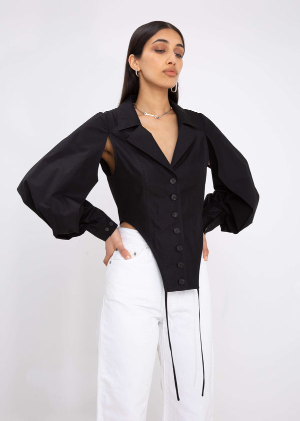 INTERNATIONAL CITIZEN.  Style: A French Cut Button Bodysuit with tie closures. It features exaggerated sleeve volume pleated at the cuffs, with an open under arm for breathability. Close up front view. Made of Italian Organic Cotton, Obsidian Black. Spiritually Infused, Sustainable Luxury Fashion in Berlin.