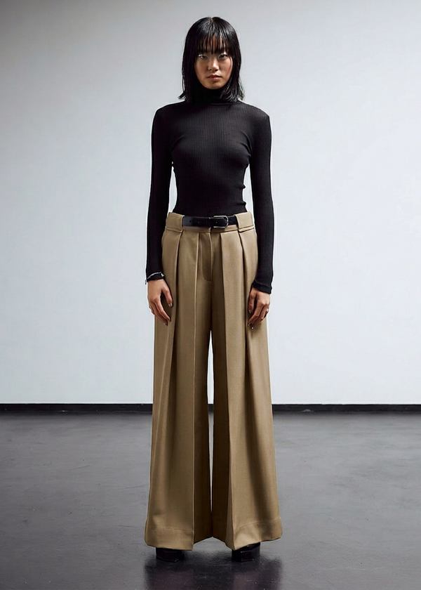 INTERNATIONAL CITIZEN.  Style: The Deep Pleated Pant, falls below the natural waist. The pleats nearly meet at the center front. Made of Italian Organic Cotton, Dune. Spiritually Infused, Sustainable Luxury Fashion in Berlin.