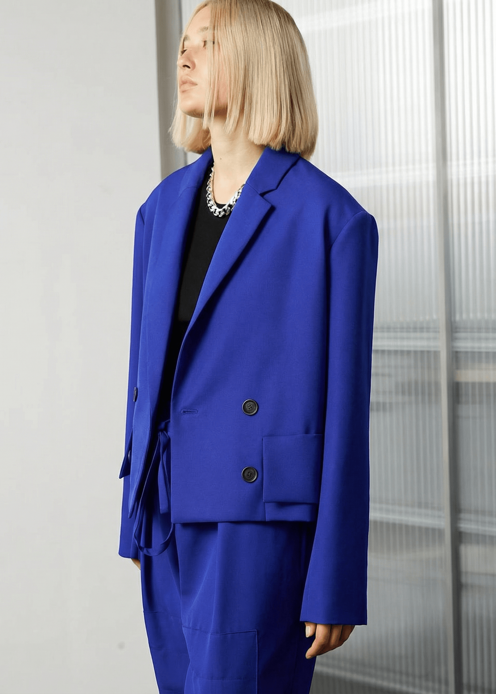 INTERNATIONAL CITIZEN.  Style: The Oversized Men’s Jacket features classic mens tailoring details. Side front view. Unisex item. Made of Italian Wool RWS, Lapis Lazuli Blue. Spiritually Infused, Sustainable Luxury Fashion in Berlin.