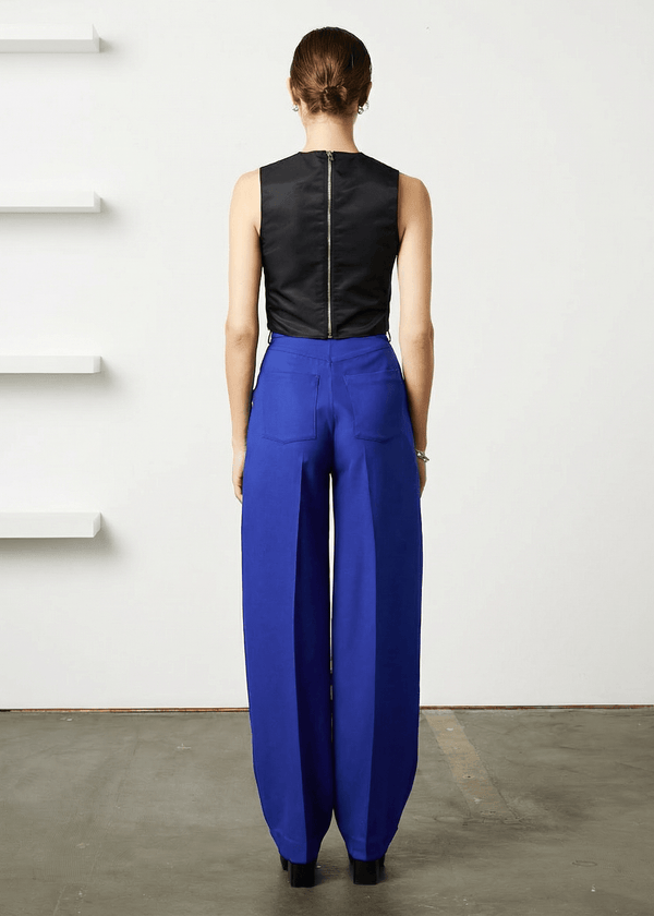 INTERNATIONAL CITIZEN.  Style: The Ribcage Trouser is a high waisted pant, featuring denim style detailing in the back body. Made of Italian Wool RWS, Lapis Lazuli Blue. Spiritually Infused, Sustainable Luxury Fashion in Berlin.