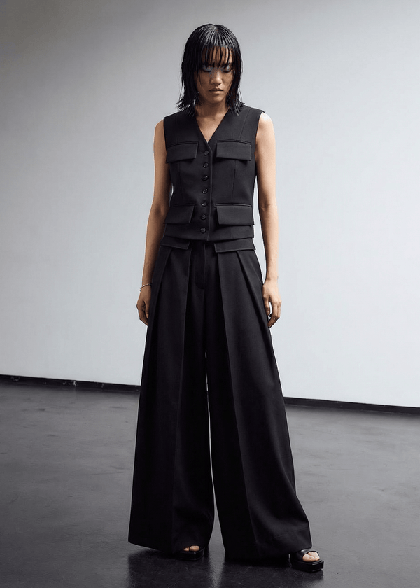 INTERNATIONAL CITIZEN.  Style: The Deep Pleated Pant, falls below the natural waist. Full front photo. Made of Italian RWS Wool, Obsidian Black Purple. Spiritually Infused, Sustainable Luxury Fashion in Berlin.