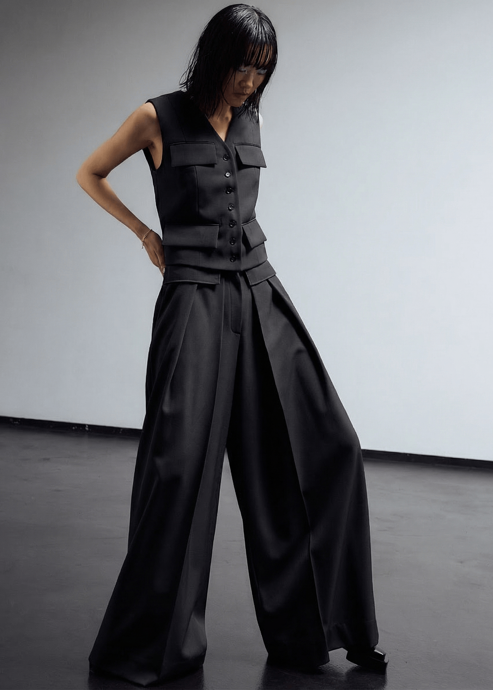 INTERNATIONAL CITIZEN.  Style: The Deep Pleated Pant, falls below the natural waist. Made of Italian RWS Wool, Obsidian Black Purple. Spiritually Infused, Sustainable Luxury Fashion in Berlin.
