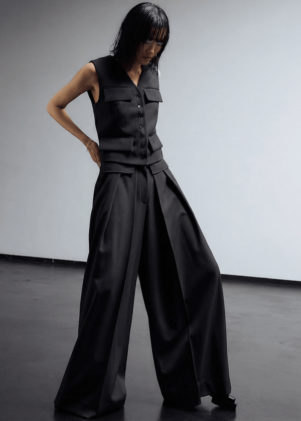 INTERNATIONAL CITIZEN.  Style: The Deep Pleated Pant, falls below the natural waist. Made of Italian RWS Wool, Obsidian Black Purple. Spiritually Infused, Sustainable Luxury Fashion in Berlin.