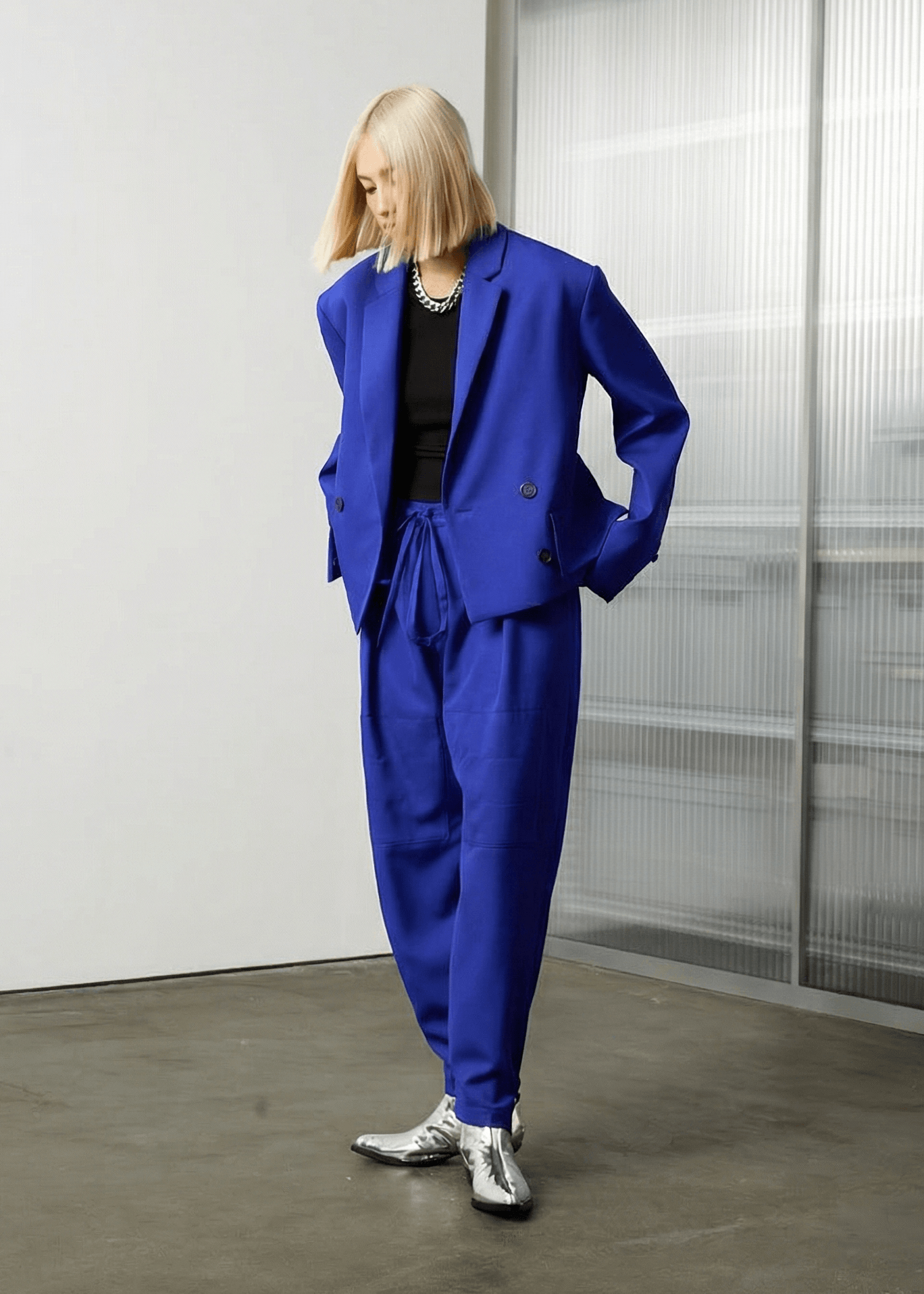 INTERNATIONAL CITIZEN.  Style: The JiuJitsu Pants are have a drawstring closer at the waist. Full body view. Unisex item. Made of Italian Wool, certified (RWS) Responsible Wool Standard, Lapis Lazuli Blue. Spiritually Infused, Sustainable Luxury Fashion in Berlin.