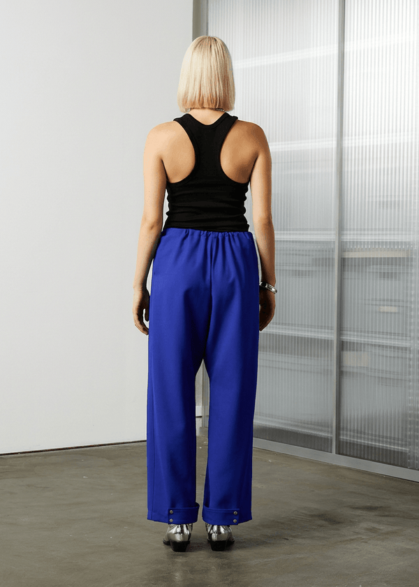 INTERNATIONAL CITIZEN.  Style: The JiuJitsu Pants. Back view. Unisex item. Made of Italian Wool, certified (RWS) Responsible Wool Standard, Lapis Lazuli Blue. Spiritually Infused, Sustainable Luxury Fashion in Berlin.
